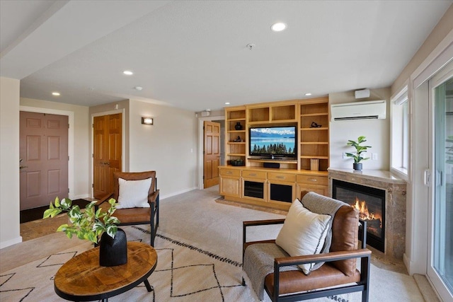 carpeted living room with a wall unit AC and built in shelves