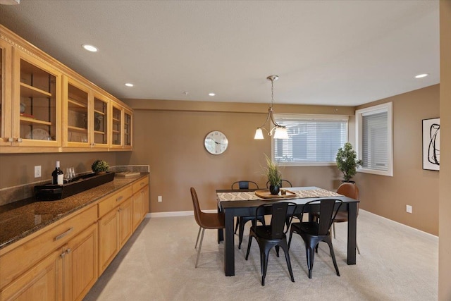 dining space featuring light carpet