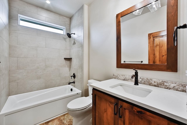 full bathroom featuring vanity, toilet, and tiled shower / bath