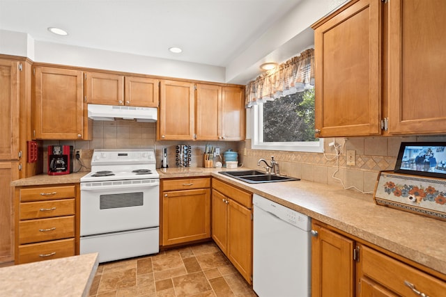 kitchen with white appliances, light countertops, a sink, and under cabinet range hood