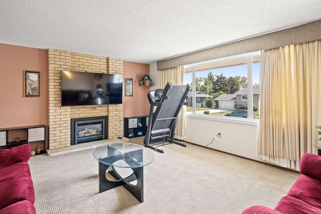 carpeted living area with a fireplace, a textured ceiling, and baseboards