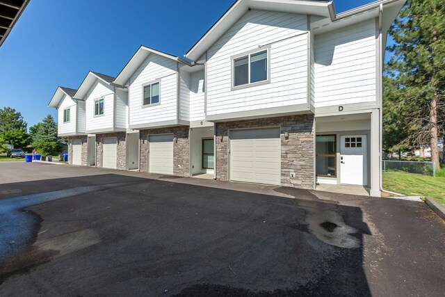 1814 E Carol St, Deer Park, WA 99006 - view of property featuring driveway, stone siding, and a garage
