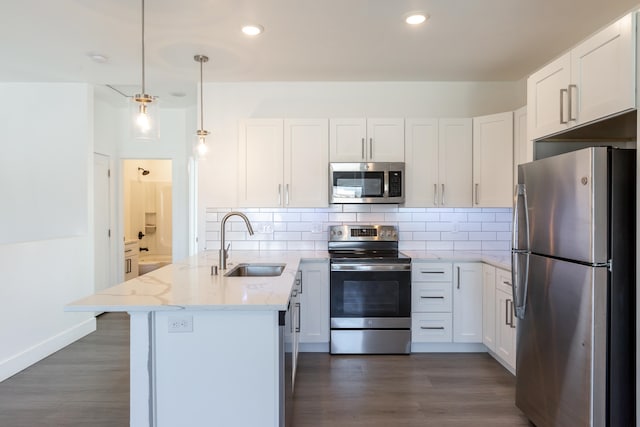 kitchen featuring stainless steel appliances, sink, decorative light fixtures, white cabinetry, and dark hardwood / wood-style flooring