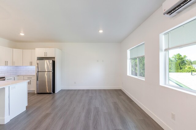 1814 E Carol St, Deer Park, WA 99006 - kitchen featuring freestanding refrigerator, a wall unit AC, light countertops, light wood-style floors, and recessed lighting