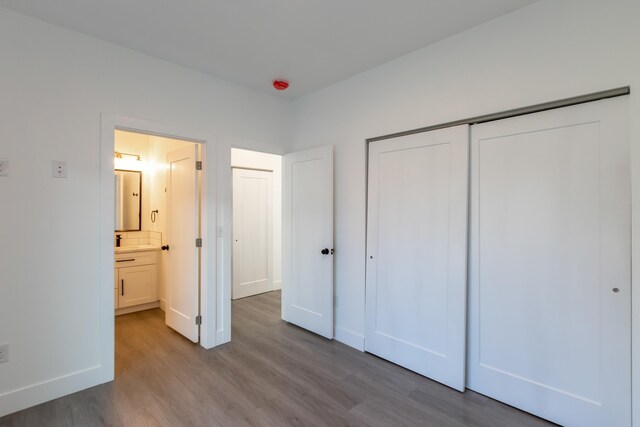 1814 E Carol St, Deer Park, WA 99006 - unfurnished bedroom featuring wood finished floors, a closet, and baseboards