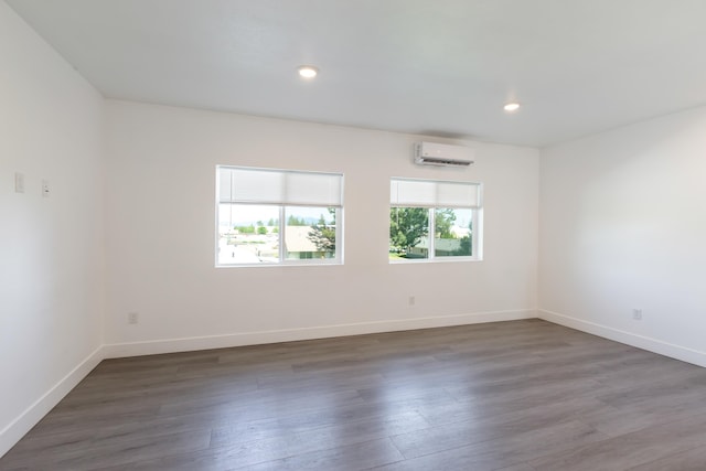 1814 E Carol St, Deer Park, WA 99006 - unfurnished room with a wall unit AC, baseboards, wood finished floors, and recessed lighting