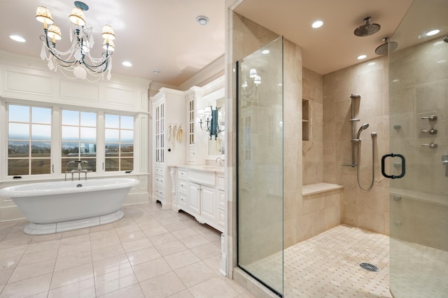 bathroom featuring vanity, an inviting chandelier, shower with separate bathtub, and tile patterned flooring