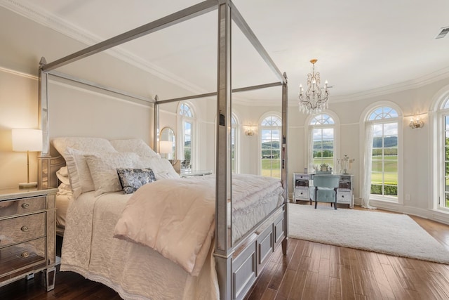 bedroom featuring dark hardwood / wood-style flooring, an inviting chandelier, and crown molding