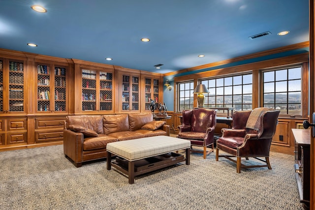 carpeted living room featuring crown molding