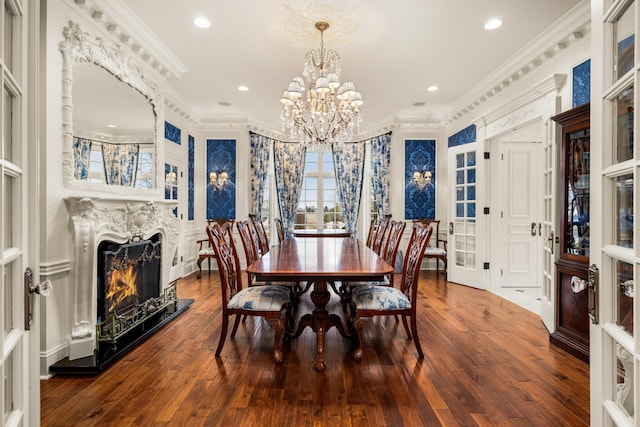 dining room featuring ornamental molding, an inviting chandelier, and hardwood / wood-style flooring