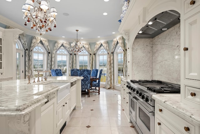 kitchen with stove, crown molding, a notable chandelier, and decorative light fixtures