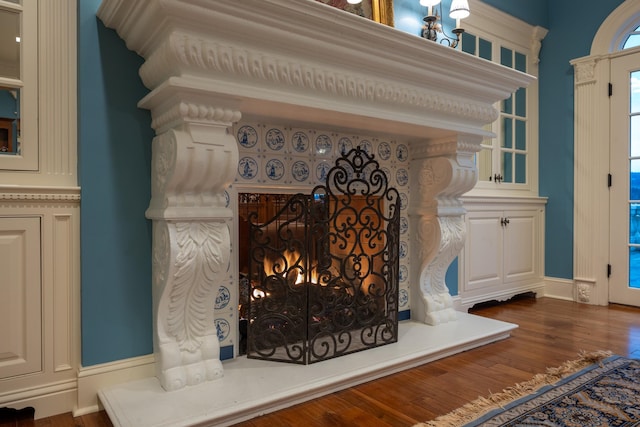 details with hardwood / wood-style flooring and a fireplace