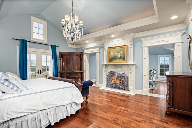 bedroom featuring multiple windows, french doors, wood-type flooring, and a notable chandelier