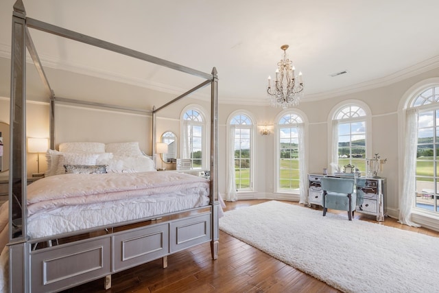 bedroom with multiple windows, a chandelier, crown molding, and hardwood / wood-style floors