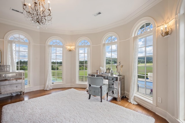 home office featuring hardwood / wood-style floors, a chandelier, and ornamental molding