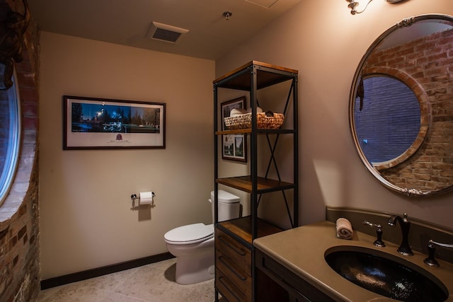 bathroom featuring vanity, tile patterned flooring, and toilet