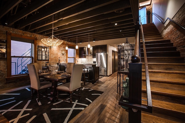 unfurnished dining area with a notable chandelier, dark hardwood / wood-style flooring, and brick wall