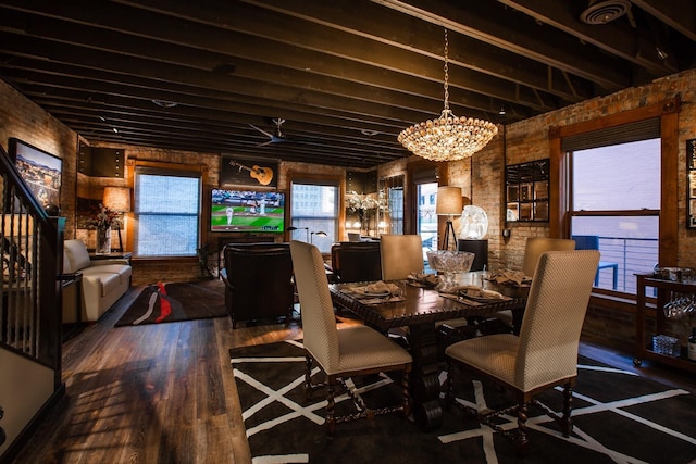 dining area with hardwood / wood-style floors and a chandelier