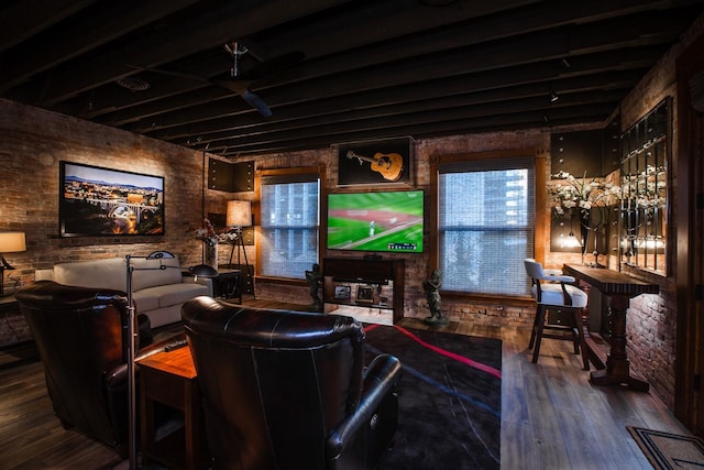 living room featuring brick wall and hardwood / wood-style flooring