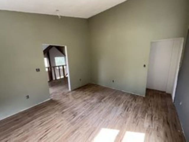 unfurnished room with hardwood / wood-style flooring