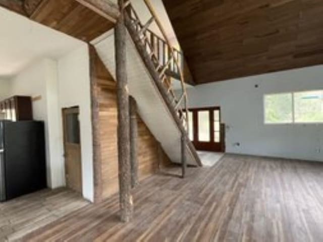 interior space with hardwood / wood-style flooring, high vaulted ceiling, and wood ceiling