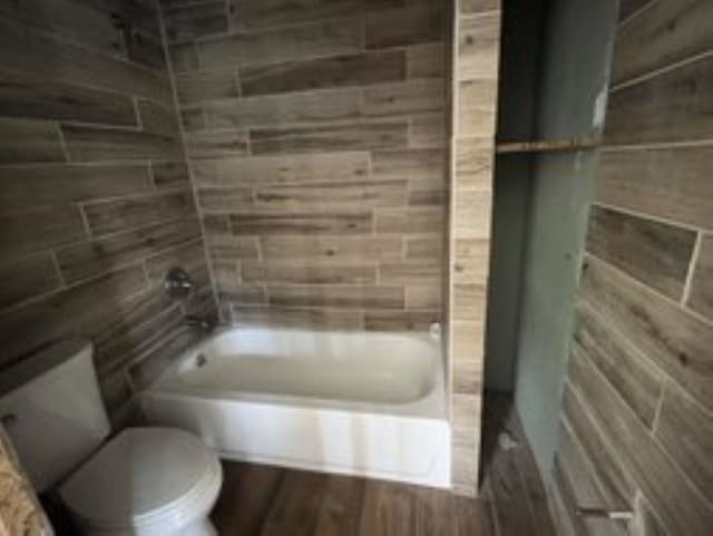 bathroom featuring shower / bath combination and toilet