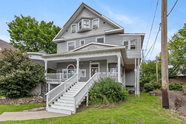 view of front facade featuring covered porch and a front yard