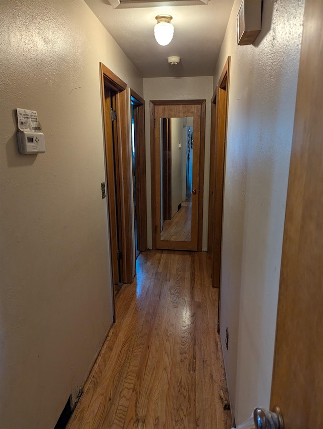 corridor featuring light wood finished floors