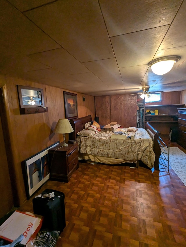 bedroom featuring wooden walls