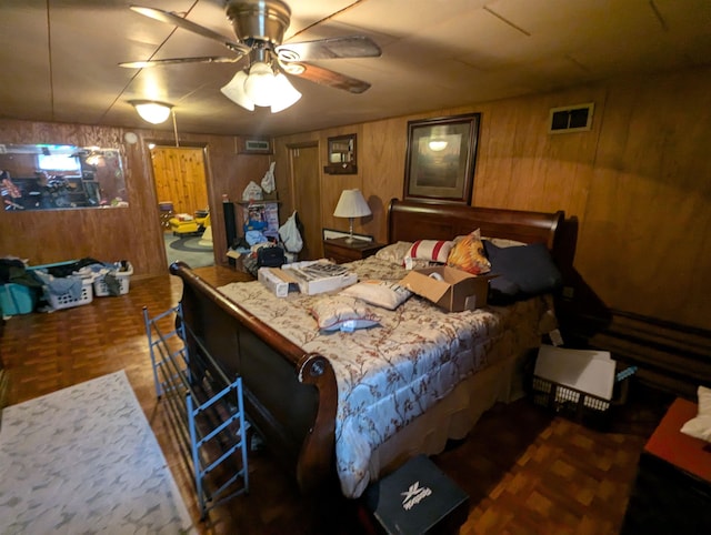 bedroom with wood walls and visible vents