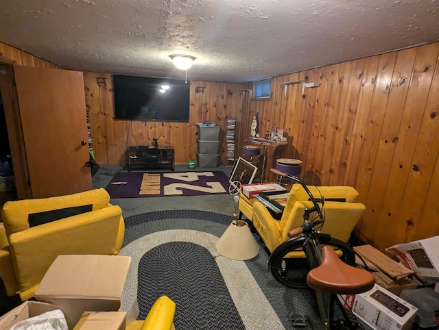 interior space with wood walls and a textured ceiling