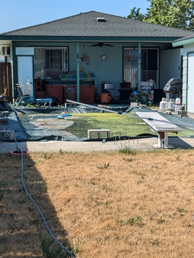 exterior space with a yard and a hot tub