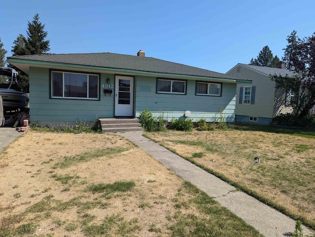 single story home with a chimney and a front yard