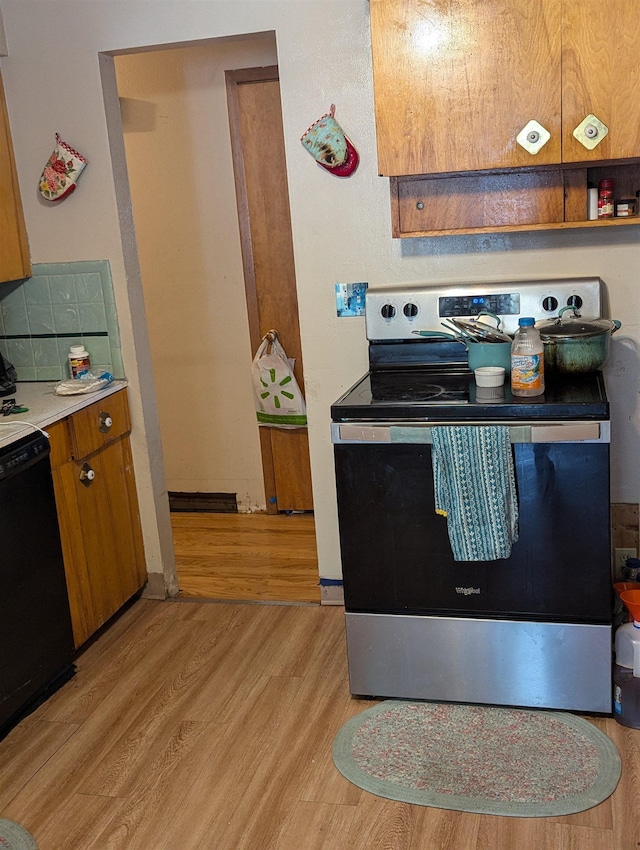 kitchen with light wood finished floors, tasteful backsplash, brown cabinetry, dishwasher, and stainless steel electric stove