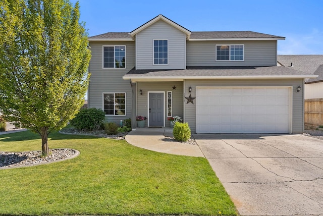 view of property featuring a garage and a front yard