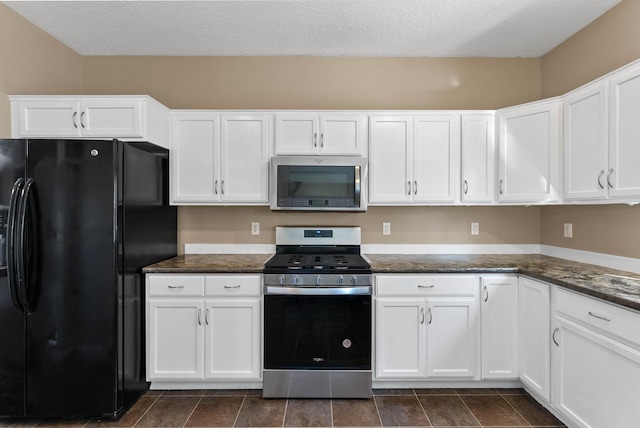 kitchen featuring appliances with stainless steel finishes, a textured ceiling, and white cabinets