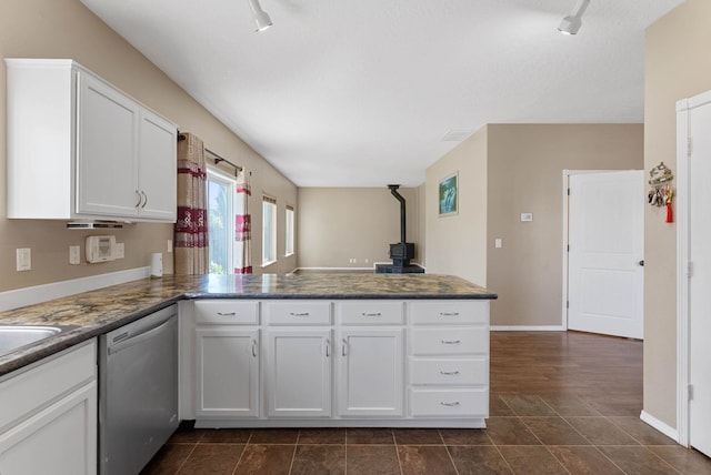 kitchen with white cabinetry, dark tile patterned floors, kitchen peninsula, and dishwasher