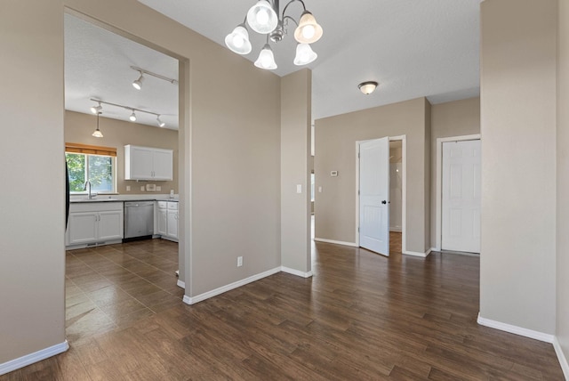 interior space with dark hardwood / wood-style floors, sink, and an inviting chandelier