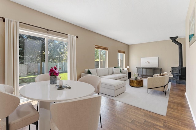 living room with a wood stove and hardwood / wood-style floors