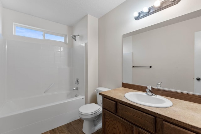 full bathroom with vanity, hardwood / wood-style floors,  shower combination, and toilet