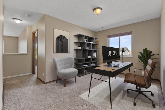 office area featuring light colored carpet and a textured ceiling