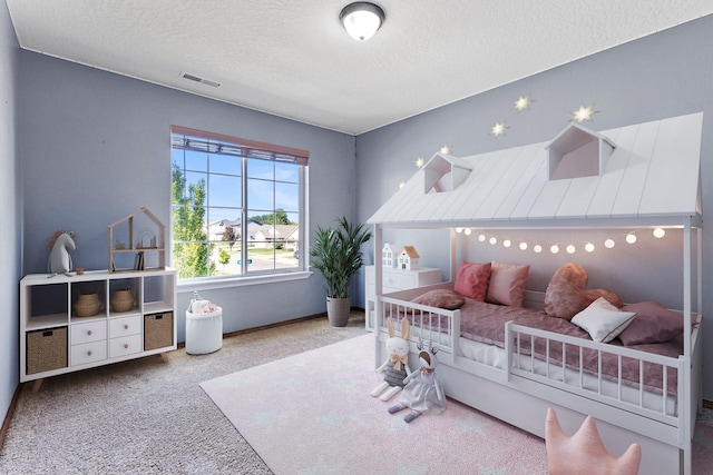 carpeted bedroom with a textured ceiling