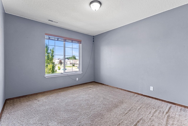 empty room featuring carpet floors and a textured ceiling