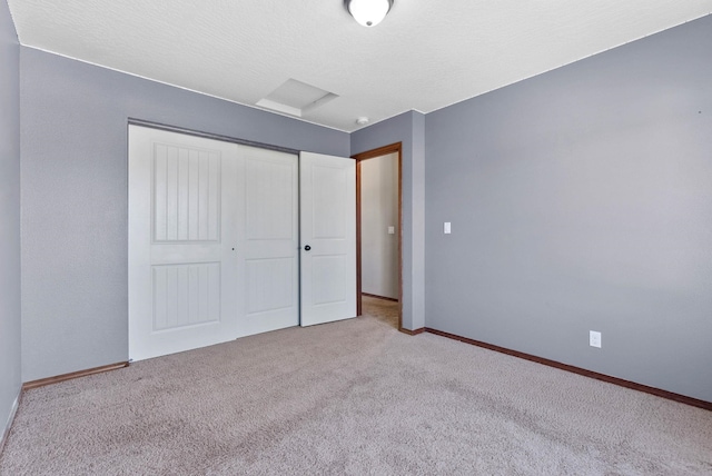 unfurnished bedroom with light carpet and a closet