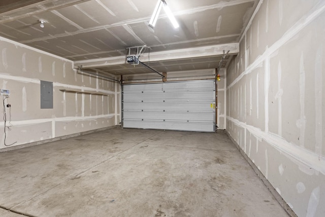 garage with a garage door opener and electric panel