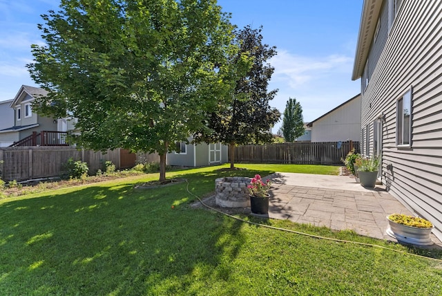 view of yard with a patio and an outdoor fire pit