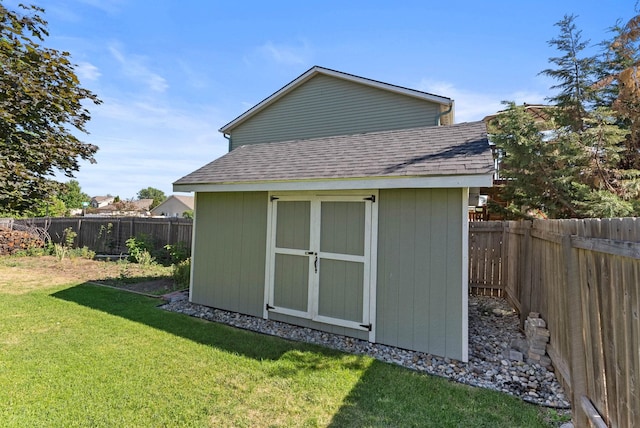 view of outbuilding with a yard