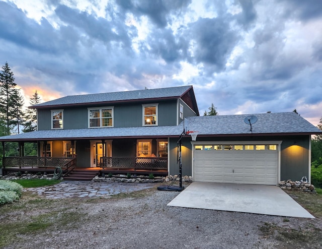 view of front of home featuring a porch and a garage