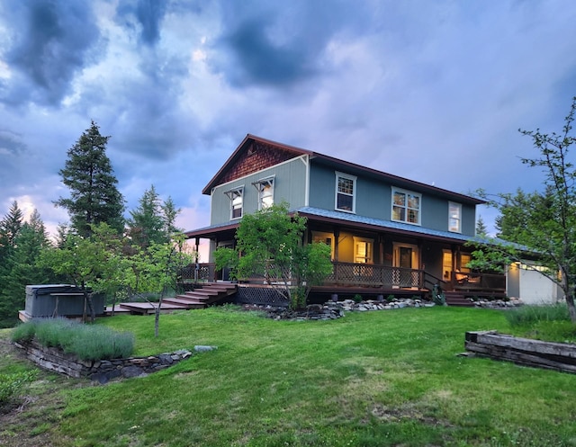 view of front of house with covered porch, an outbuilding, and a front lawn