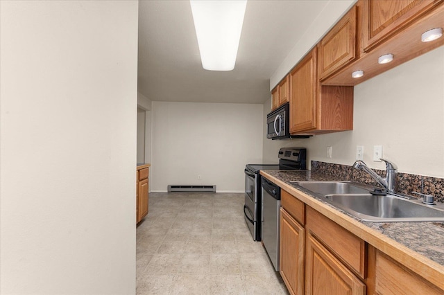 kitchen with appliances with stainless steel finishes, sink, and baseboard heating